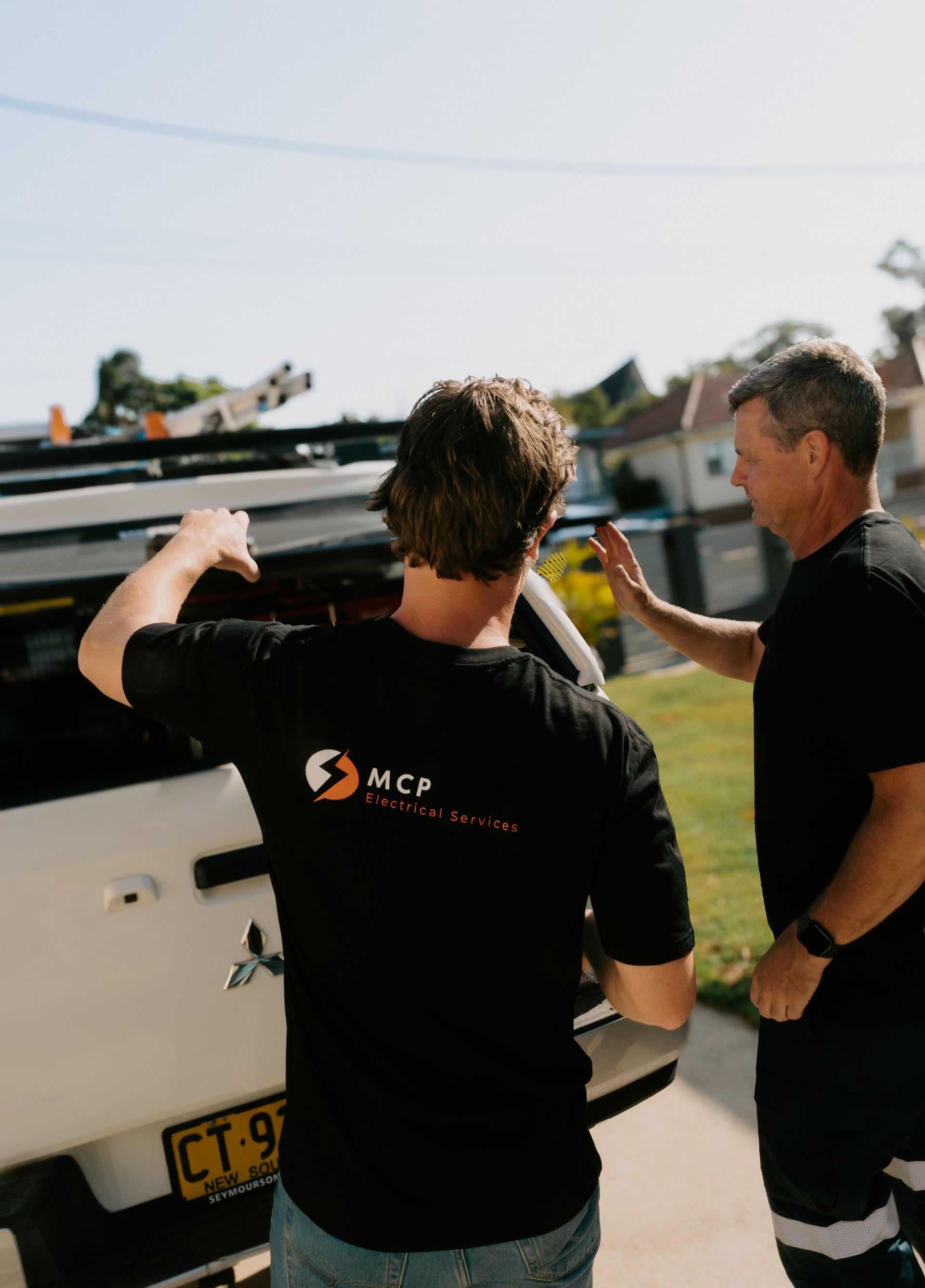 MCP Electrical Services team members unloading tools from the work van at a Newcastle job